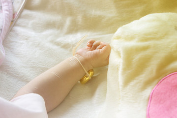 Fototapeta na wymiar little baby hand and wedding rings on pillow