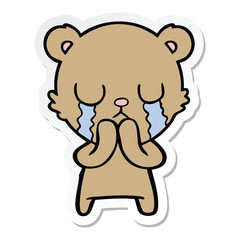 sticker of a crying cartoon bear
