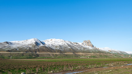 Fototapeta premium Snow covered eak of holy mountain and blue sky scenery