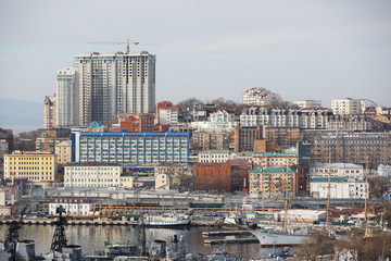 2013 - Sea facade in the capital of the Far East, the city of Vladivostok. Sea trading port with ships. Drifting ships in the raid.	
