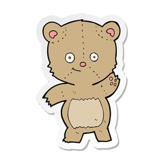 sticker of a cartoon waving teddy bear