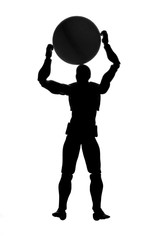 Silhouette of a man holding a ball over his head