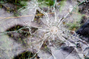 windshield broken by a stone from under the wheels of a vehicle in front