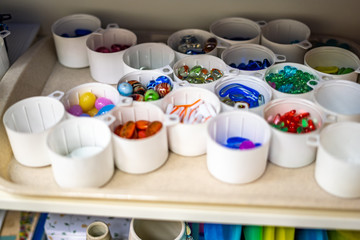Boxes with stones for educational activities for children. Neatly folded and bright, on a tray inside the tabletop. Can be used for illustrations in children's subjects. Blur applied