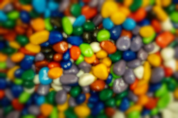 Bright multi-colored pebbles, background with blur, suitable for design.