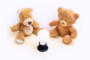 Creative idea, toys bears are sitting by the light bulb.