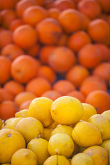 Fresh oranges and lemons close up.