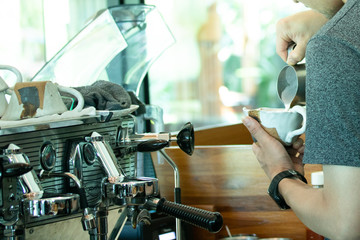 barista make latte art coffee in restaurant