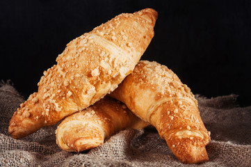 Delicious croissants on black background.