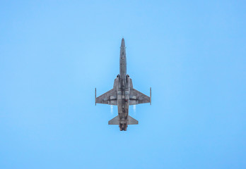 under fighter jet military aircraft flying with high speed  on blue sky background