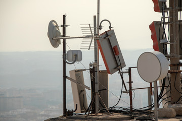 Telecommunication TV antennas with cell phone antennas and satellite dish