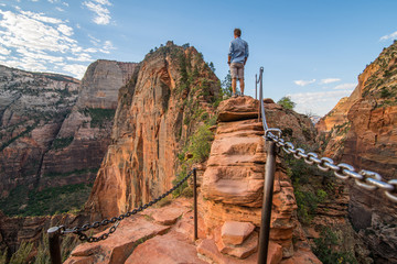 Mid 20's White Male Tourist Standing with confidence on  Angel's Landing Trail with vista. Back...