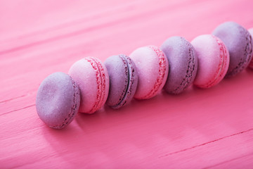 pink macaroons on wooden background