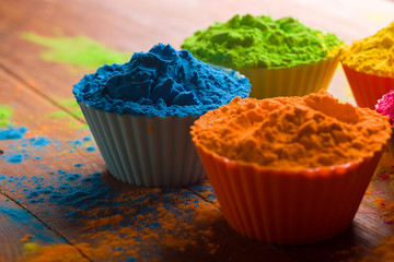Holi color powder. Organic Gulal colours in bowl for Holi festival, Hindu tradition festive