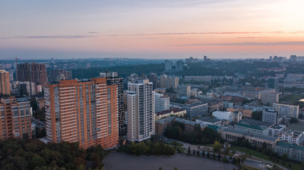 Fototapeta na wymiar Aerial top view of Kiev city skyline on sunset from above, Kyiv center downtown cityscape in evening, capital of Ukraine