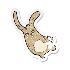 retro distressed sticker of a funny cartoon rabbit