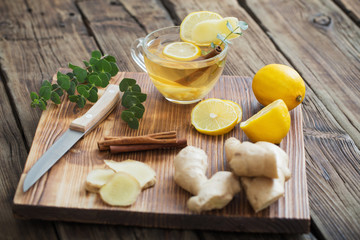 ginger and lemon tea on wooden background