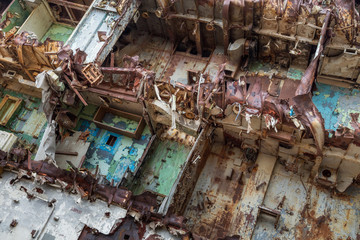 Internal parts of decommissioned marine ship that was cut and left on the shore.