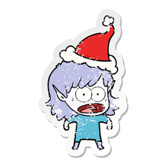 distressed sticker cartoon of a shocked elf girl wearing santa hat