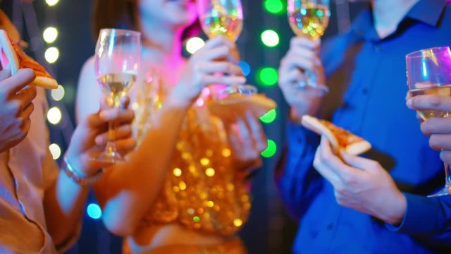 Lockdown of group of people cheering with champagne while having party