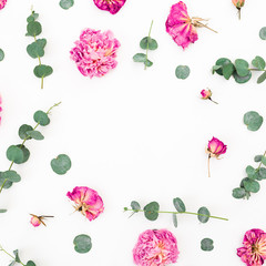 Floral pattern of pink flowers and eucalyptus branches on white background. Flat lay, top view.