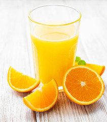 Glass of juice and orange fruits