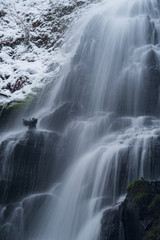 Close up details of waterfall flowing in winter