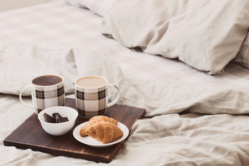 two cups of coffee on tray in bedroom