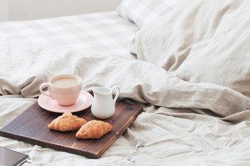 coffee in pink cup on tray in bedroom