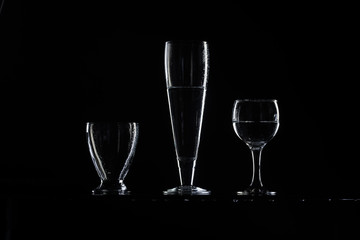 set of transparent glasses on black background 