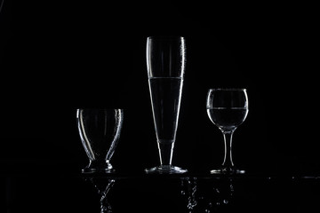 set of transparent glasses on black background 