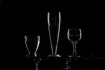 set of transparent glasses on black background 