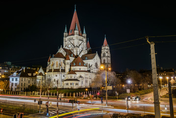 Obraz premium Vienna, Austria - December 29, 2017. St. Francis of Assisi Church, or Emperor's Jubilee Church, or Mexico Church, is Basilica-style Catholic church. Night view of Art Nouveau landmark building.