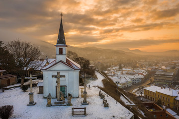 Esztergom, Hungary - Amazing golden sunrise at the Sorrowful Virgin Chapel on a misty winter morning