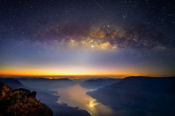 Naklejka na ściany i meble Landscape Milky Way rises over on mountain Pha Daeng Luang, Mae Ping National Park, Lamphun in Thailand