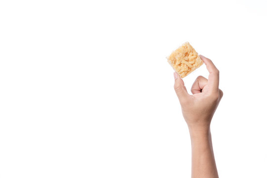 Hand holding khao soi tud, traditional Thai snack
