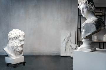 God Apollo bust sculpture and bust of the Farnese Hercules. Head sculpture, plaster copy of a...
