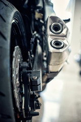 View of the back of a motorcycle with an emphasis on the chain.