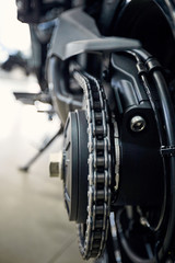 View of the back of a motorcycle with an emphasis on the chain.