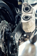 View of the back of a motorcycle with an emphasis on the chain.