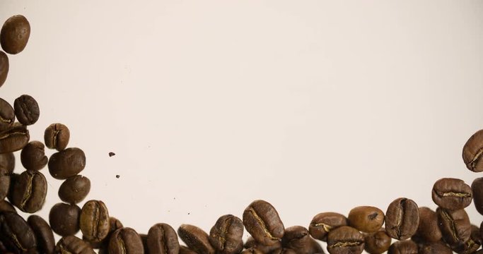 Hand removing coffee beans for Copyspace for text or logo Coffee Background abstract Slow motion bottom view 4K video