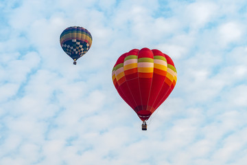 Colorful hot air balloons floating above the lake in Chiang Rai, Thailand