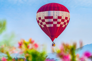 Colorful hot air balloon floating above the lake in Chiang Rai, Thailand