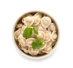 Bowl with tasty dumplings on white background