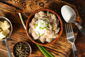 Bowl with tasty dumplings on table