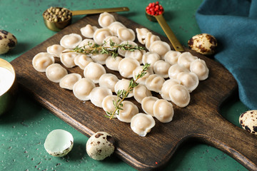 Fototapeta na wymiar Board with tasty dumplings on table