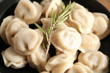 Tasty dumplings in pan, closeup