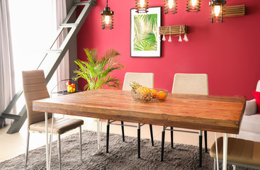 Big wooden table with chairs in interior of modern room