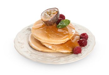 Tasty pancakes with passion fruit and berries on white background