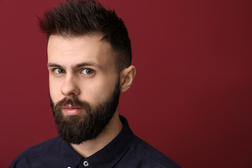Portrait of handsome young man on color background